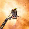 A fire fighter stands on top of a cherry picker pouring water onto a fire below