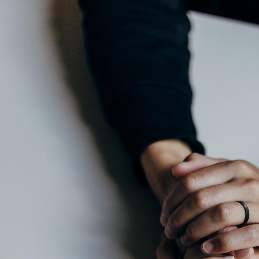 two people holding hands in support