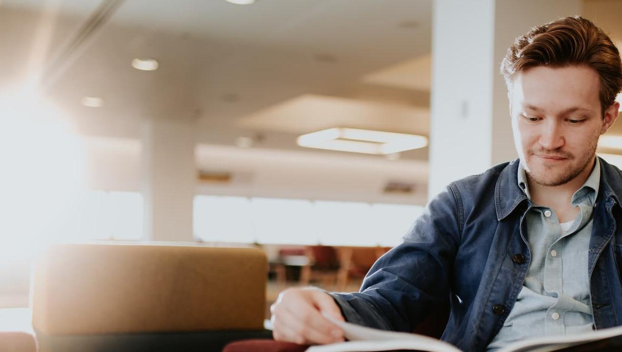 History student, Ethan Harding, reading in the Brynmor Jones Library at the University of Hull.