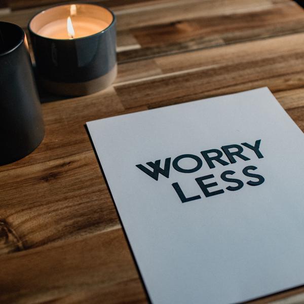 a calming table with a candle and the words 'worry less'