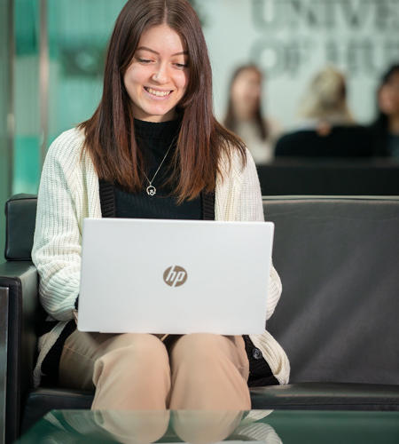 Sapphire Jackson-Yoxall sat in the business school foyer on her laptop