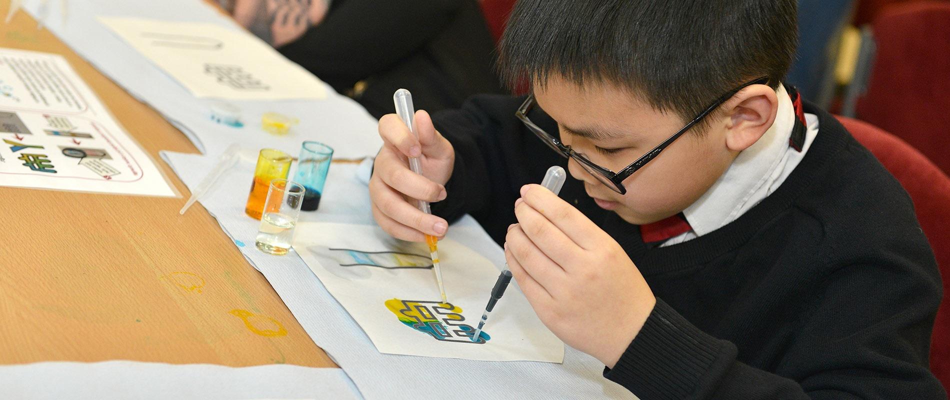 Primary-school-child-taking-part-in-lab-on-a-chip-activity-flipped-cropped-1900x800