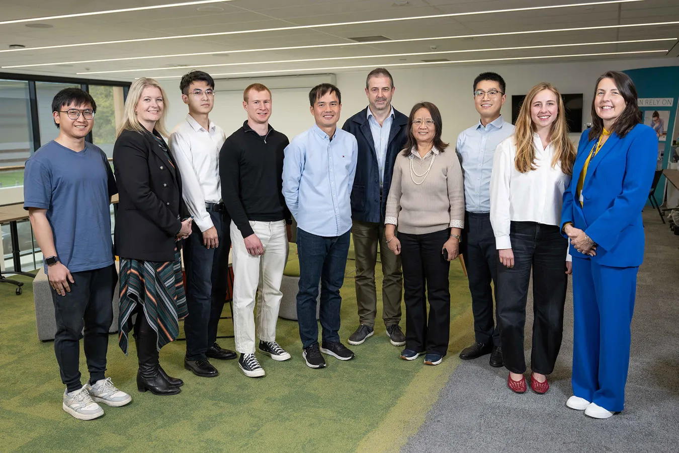 10 people from the Dew Point research and spin-out collaborators stand smiling in a group