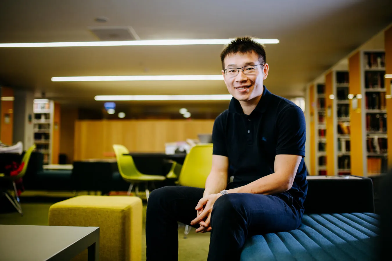 international student sitting in a library study space