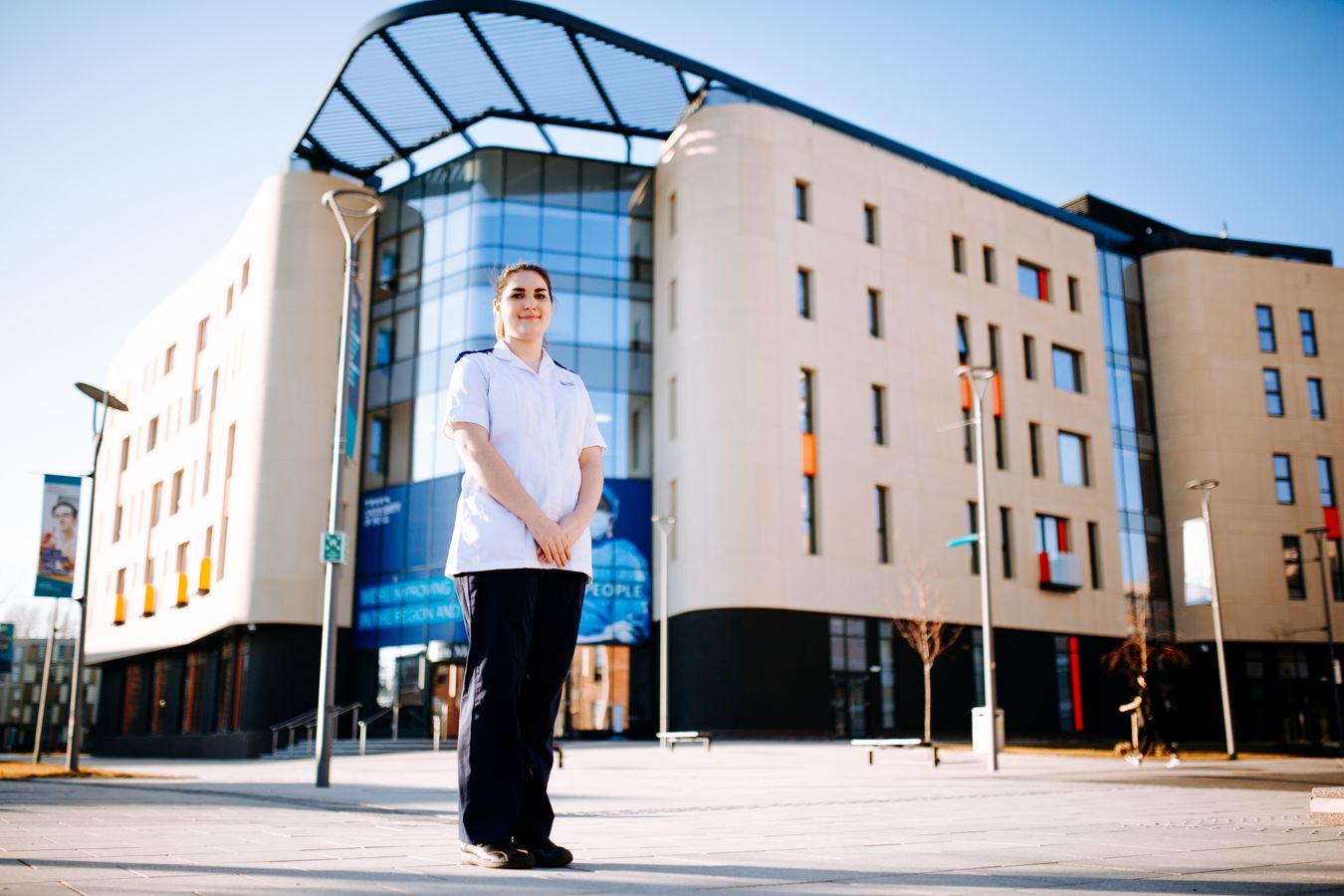 A student nurse stood out side the Allam Medical Building