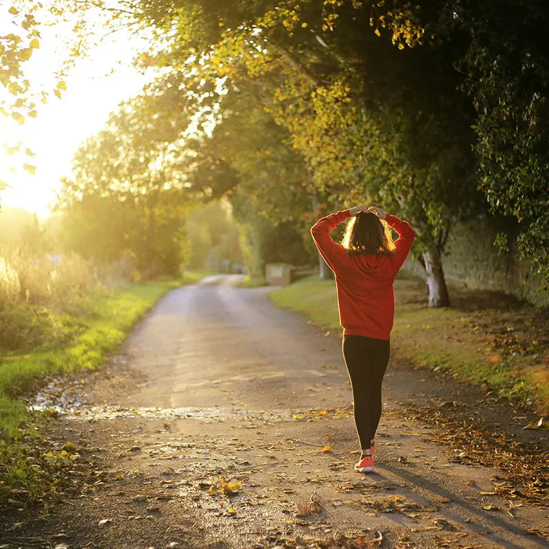 Woman walking down a country lane