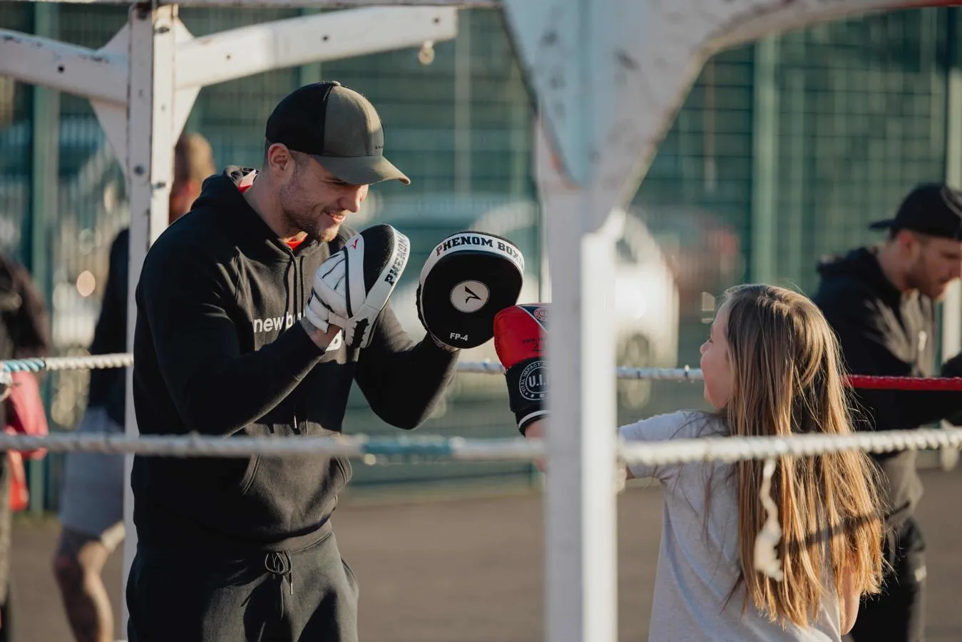 Two young people sparring using boxing equipment 