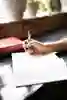 Female hand writing with a pen in a notepad