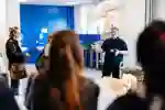 Schools and college team member delivering talk to a school group