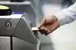 Commuter using a ticket machine at the train station
