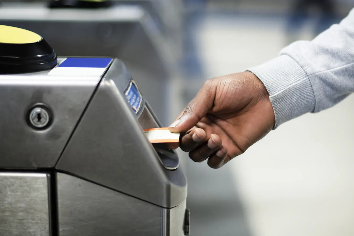 Commuter using a ticket machine at the train station