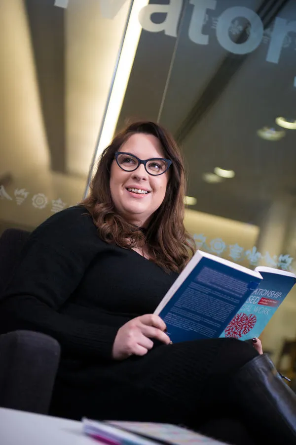 Melanie Garlick reads a book on social work