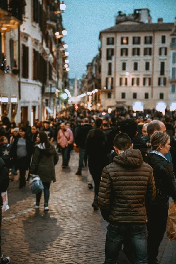 Crowded street scene with a young man in the foregound