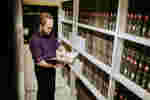 A students reads a book in front of library shelves
