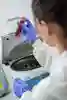 Student looks at a test tube in a lab