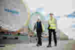 Two placement students on site wearing high-vis and hard hats