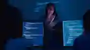 Lecturer stands in front of students on computers