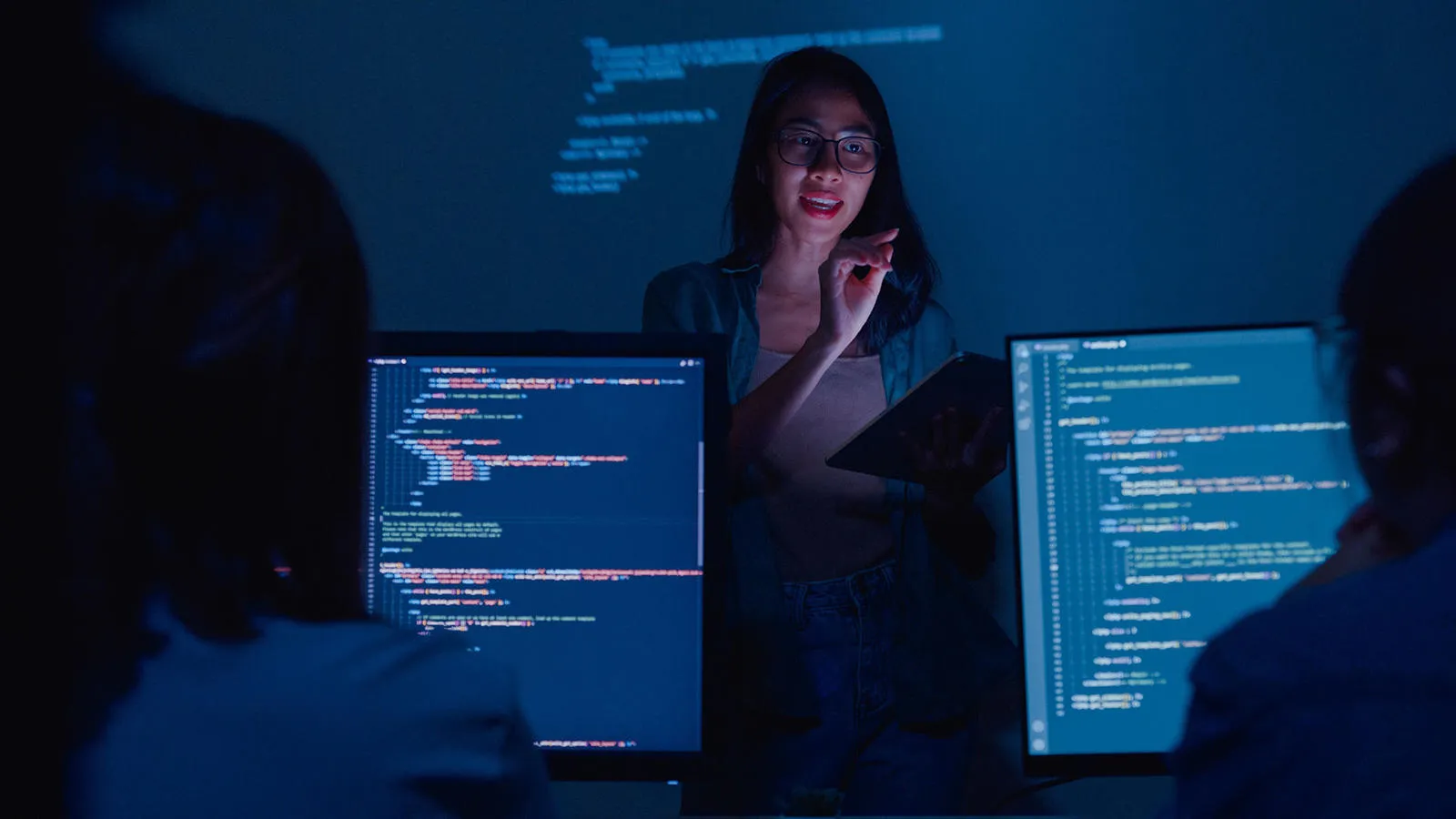 Lecturer stands in front of students on computers
