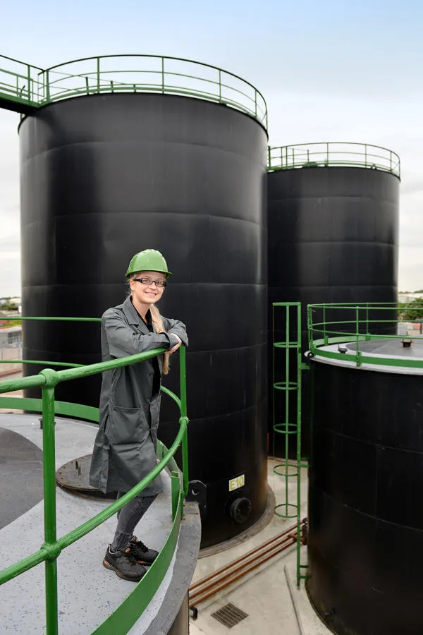 Student in hard hat standing at railing 