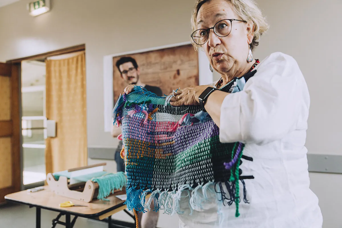 A workshop participant shows off her water-inspired textiles work