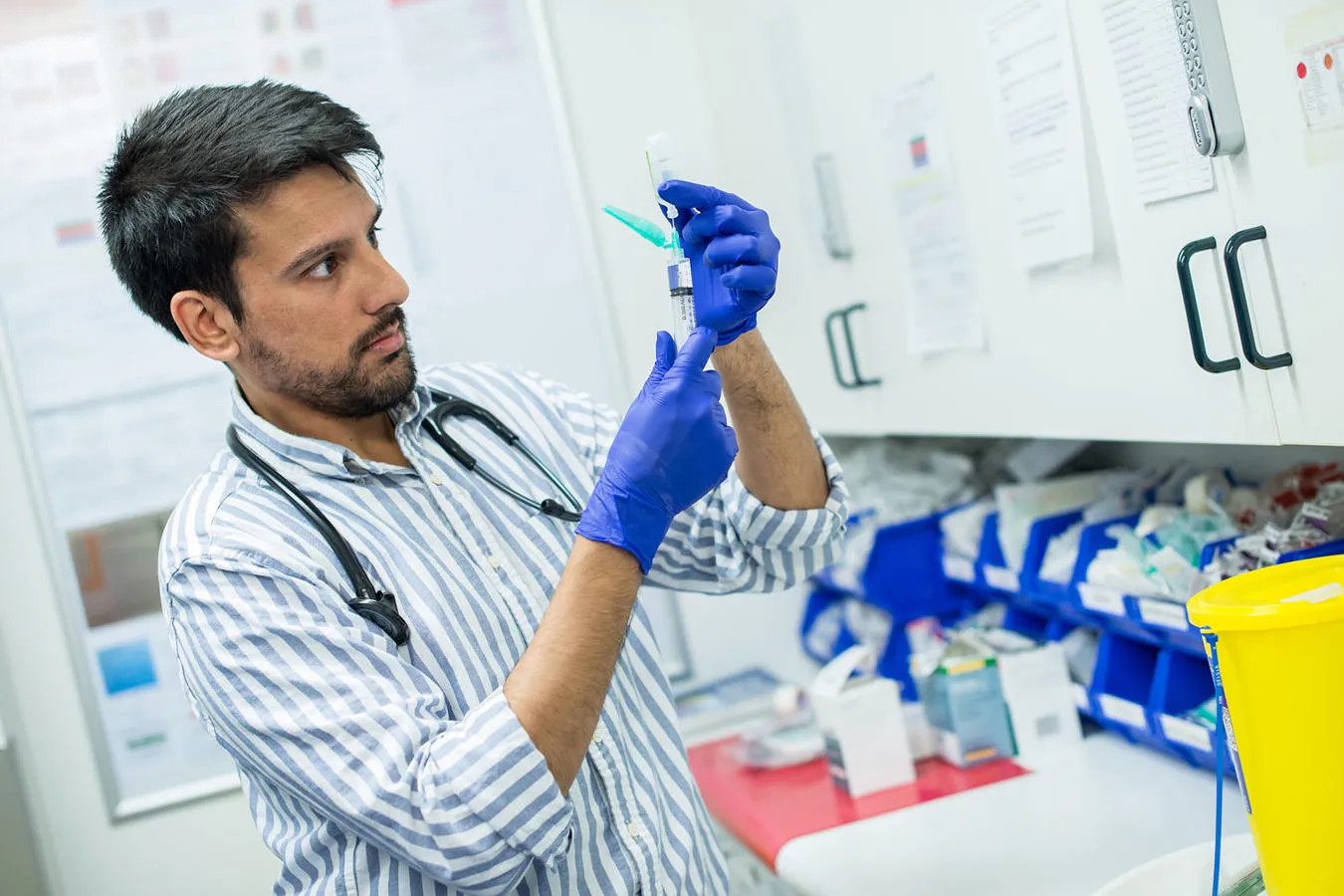 Junior doctor preparing a syringe