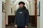 student stood in university arched hallway
