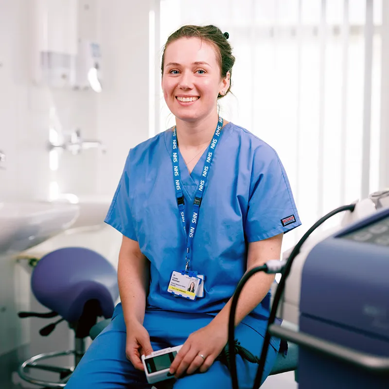 Dr Louise Hitchman, Wound specialist clinician and researcher in blue scrubs