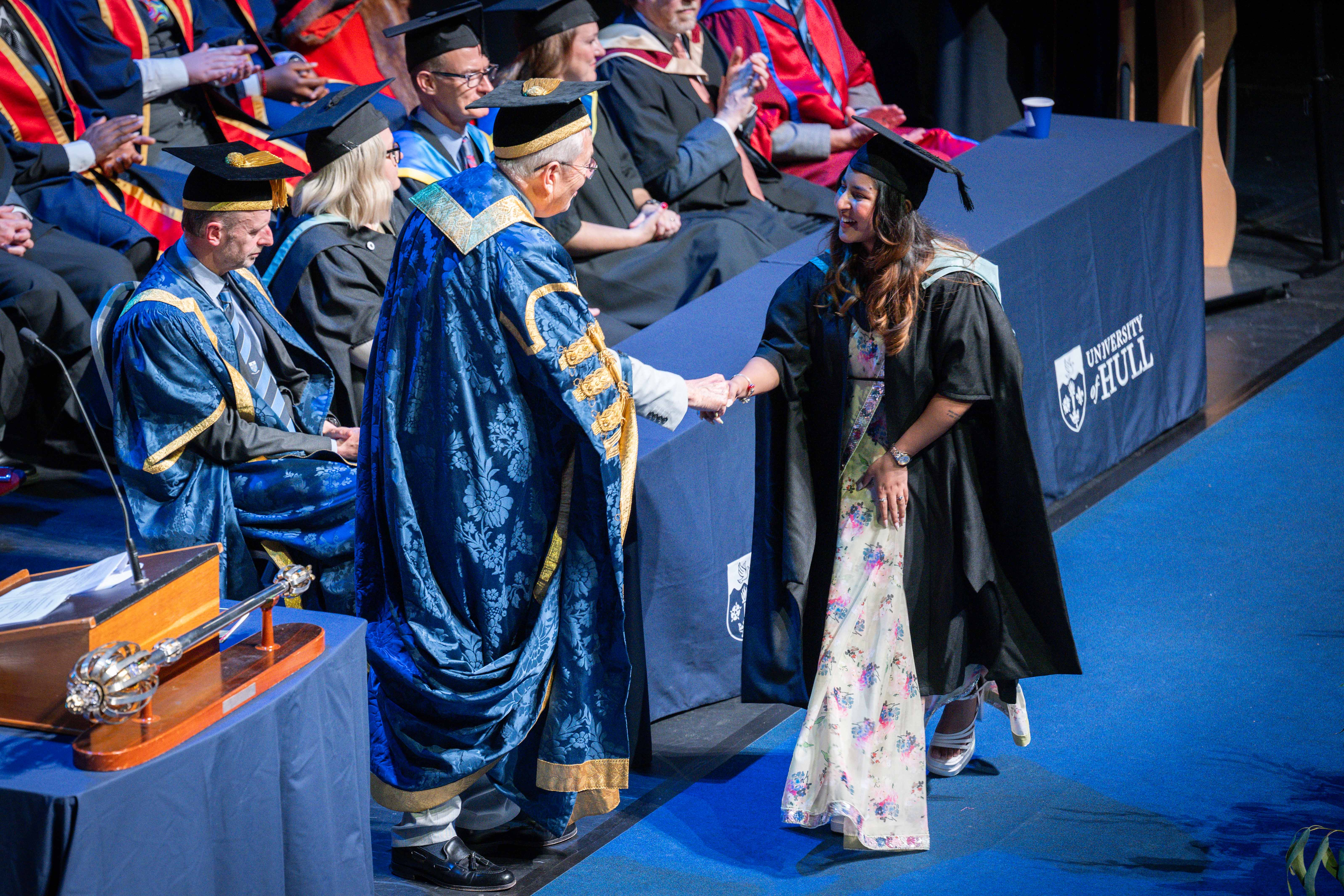 Graduand shakes hands with Chancellor at University of Hull graduation.