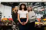 Three students in Trinity covered Market.
