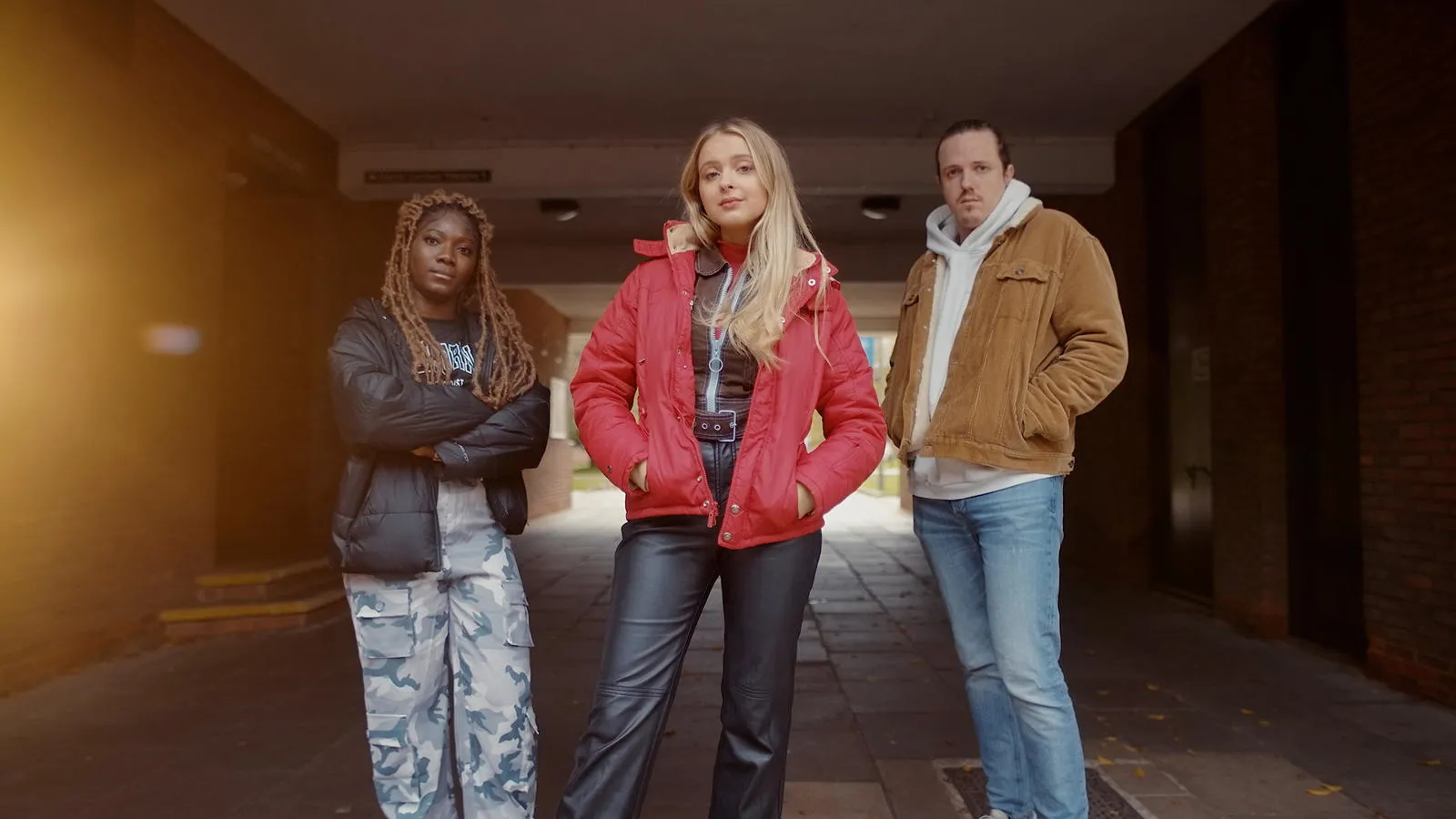 3 students posing in the tunnel