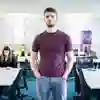 Student stood posing in front of classroom