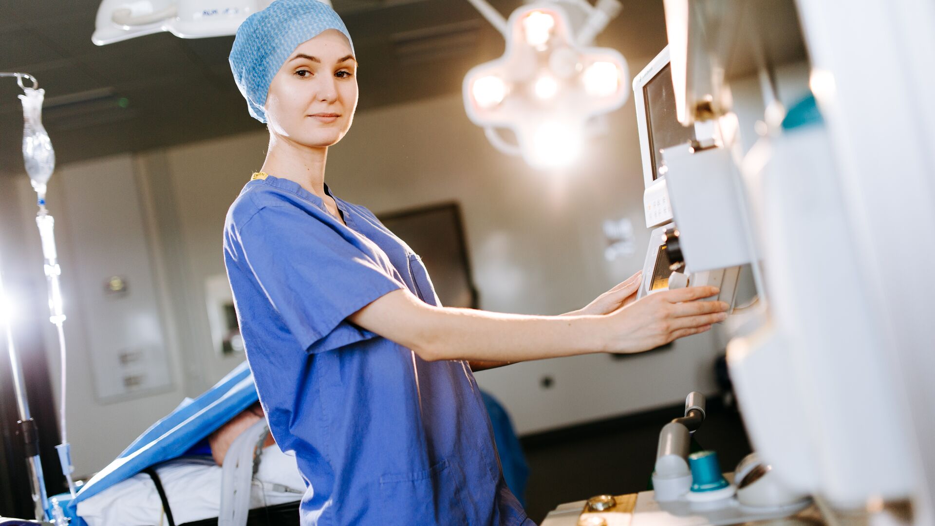 Two operating department practice students wearing scrubs in an operating theatre