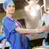 Two operating department practice students wearing scrubs in an operating theatre