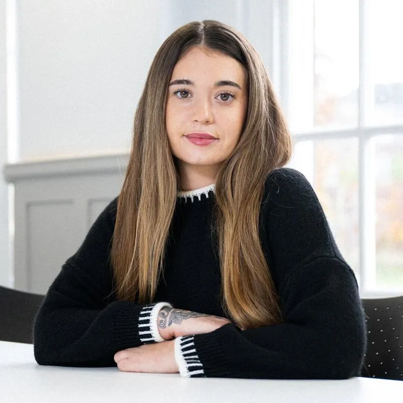 A student sat at a table in front of a window