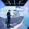 A student wearing a VR visor standing in the HIVE cube