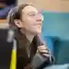 A student smiles whilst watching their lecturer