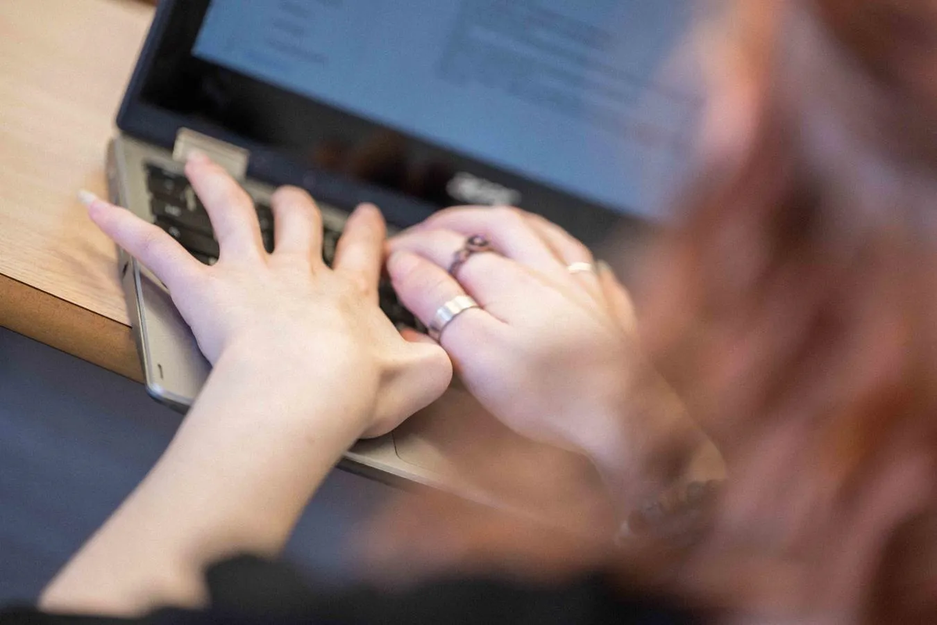 Student typing on laptop