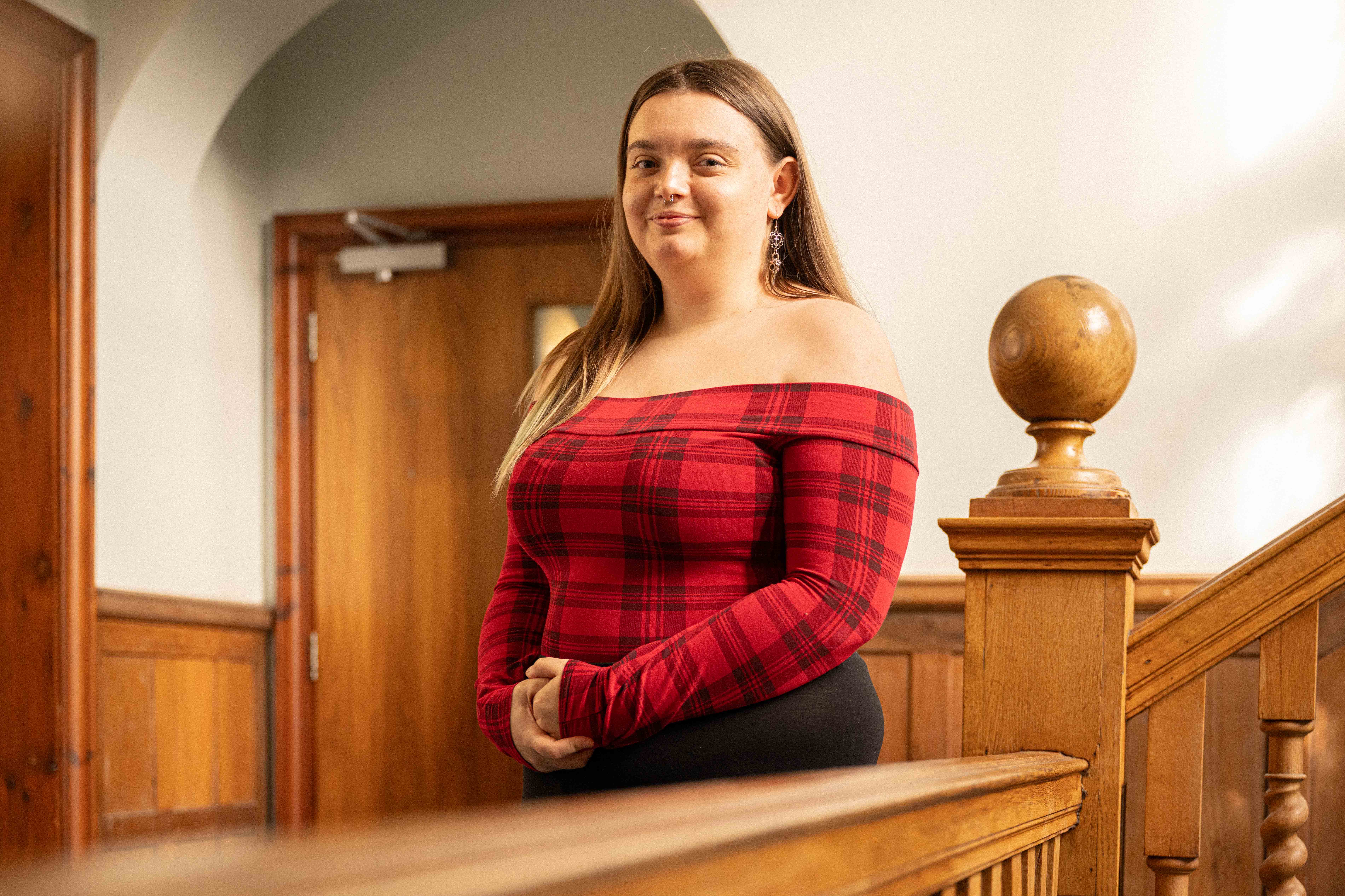 A woman posing on a railing