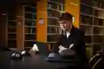 Student sat in the library looking at laptop