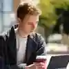 A student on a laptop on a picnic table