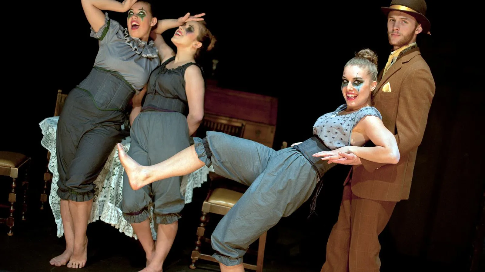 Four students acting on stage