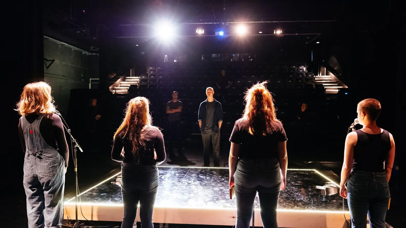 four students stood on stage