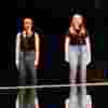 four students stood on stage