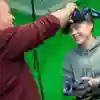 A student wearing a VR headset on a green screen