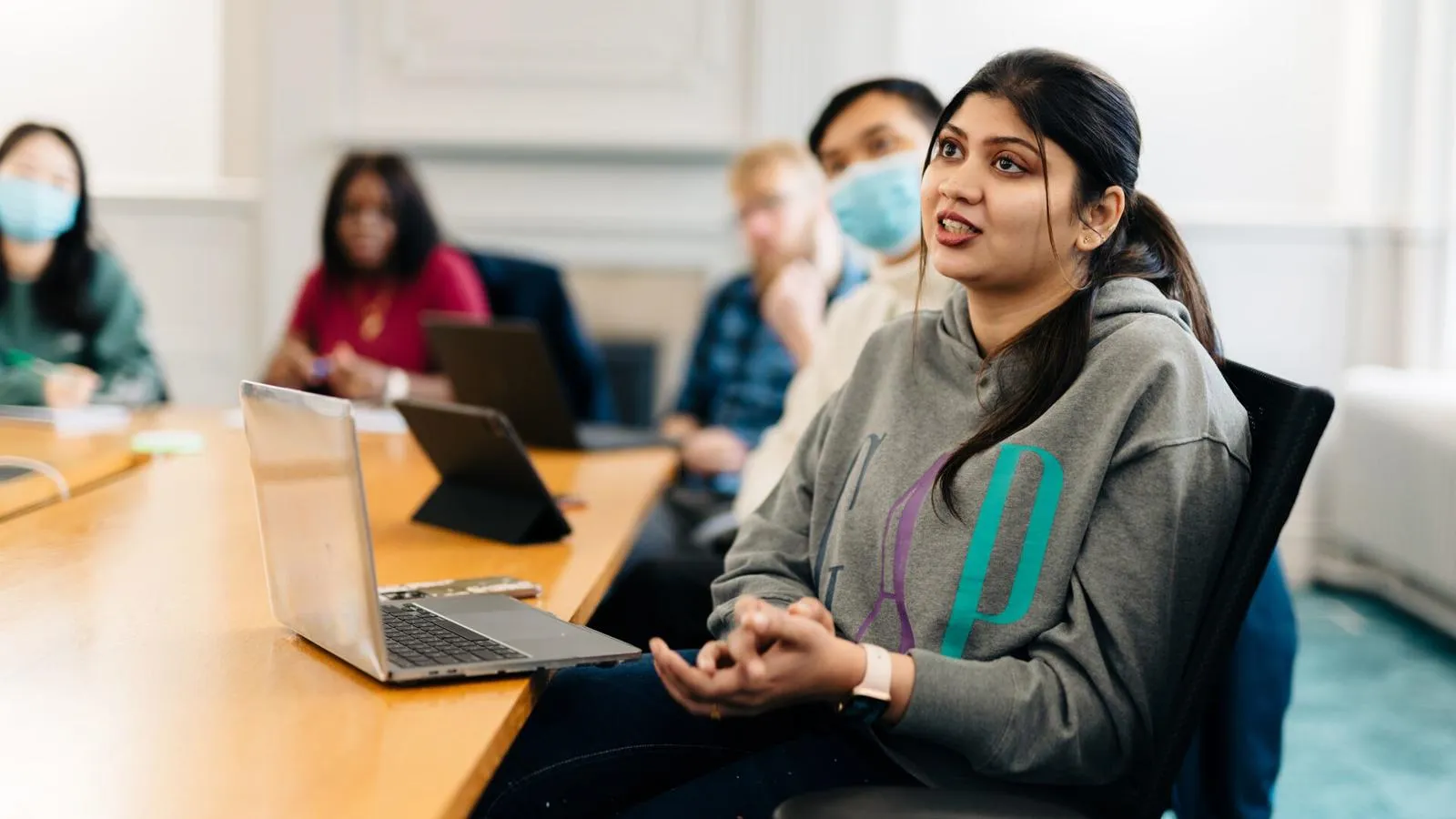 Student sat at desk in a seminar