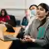 Student sat at desk in a seminar