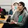 Student sat at desk in a seminar