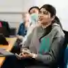 Student sat at desk in a seminar