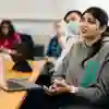 Student sat at desk in a seminar