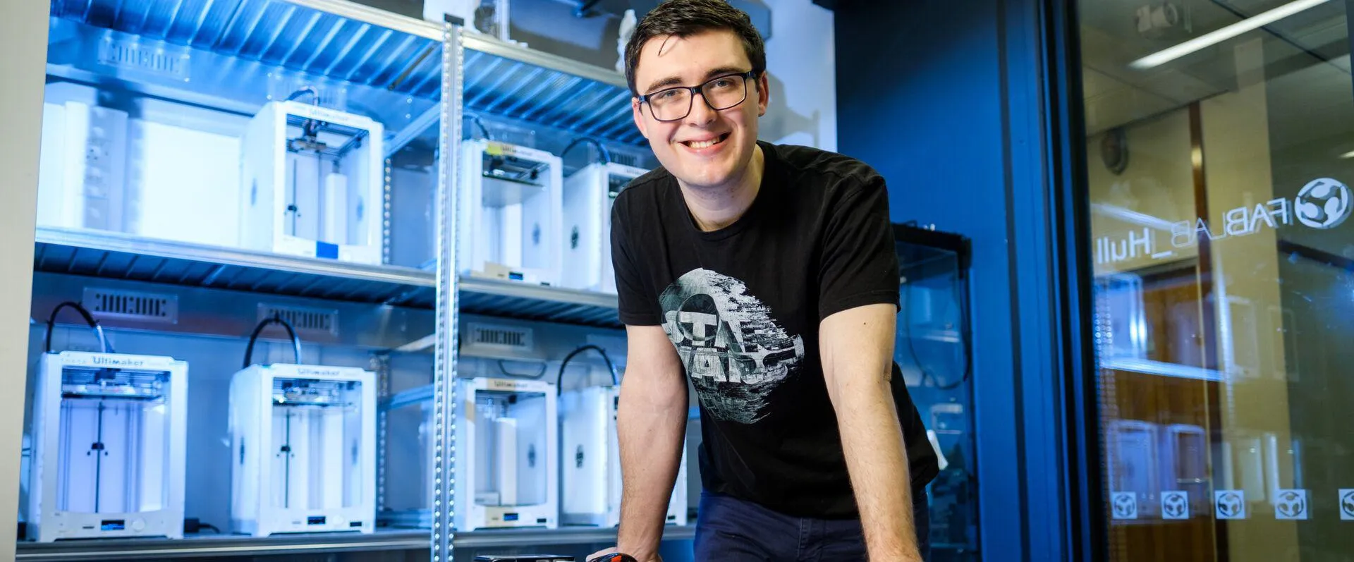 A student in the Swift Additive Manufacturing Space with 3D printed equipment